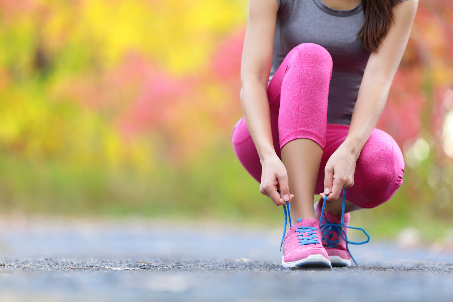 A jogger lacing up her trainers ready for a run while using a menstrual cup