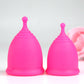 Two fuchsia coloured menstrual cup in medium and large sizes 